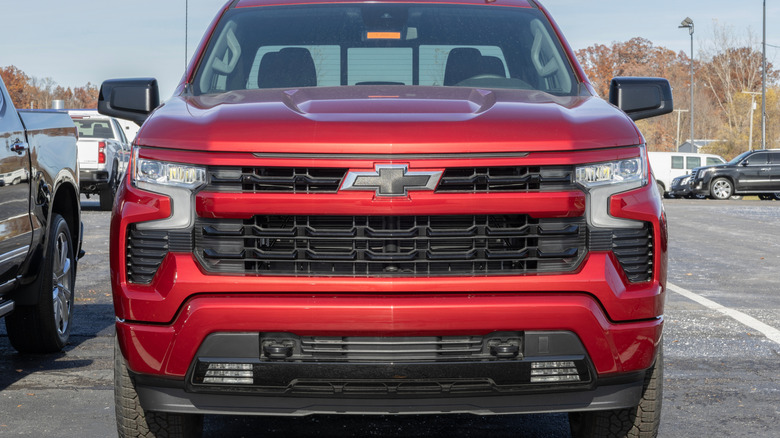 A front-end view of a red Chevrolet Silverado 1500.
