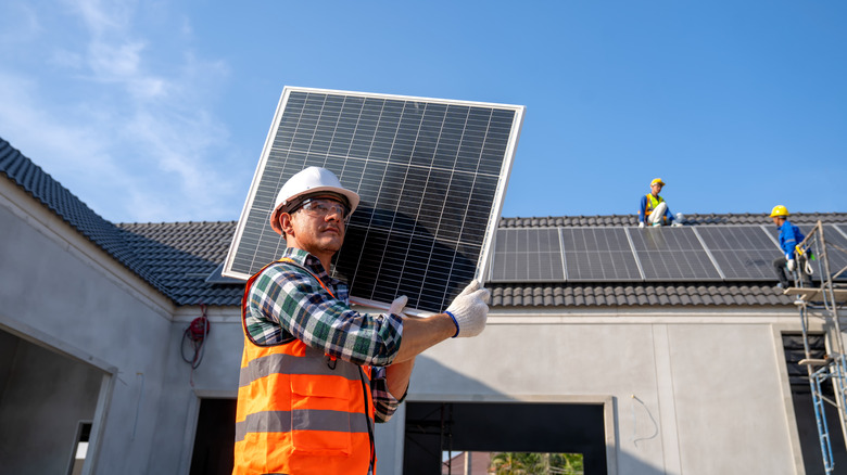 Professionals installing rooftop solar