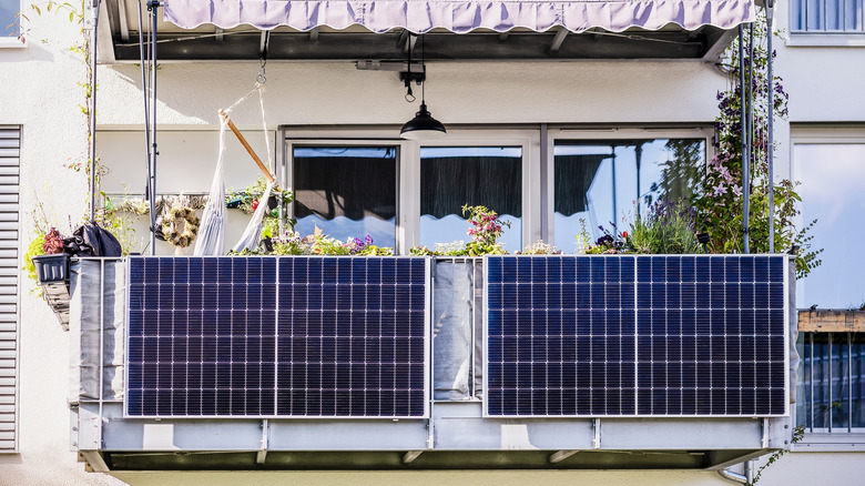 Two solar panels hang on balcony