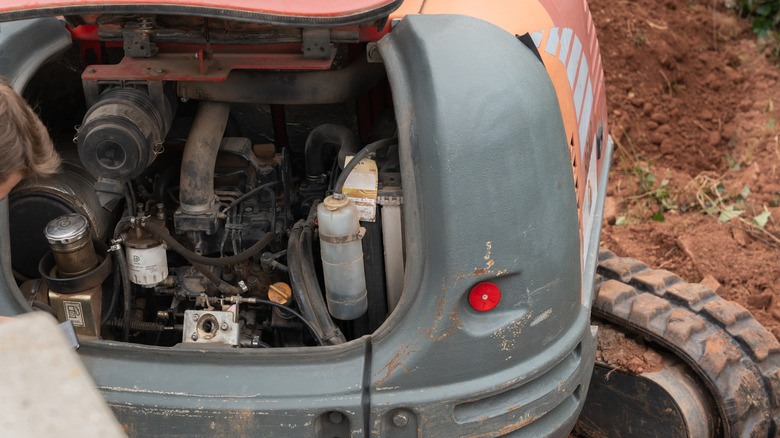Open engine compartment of a small excavator