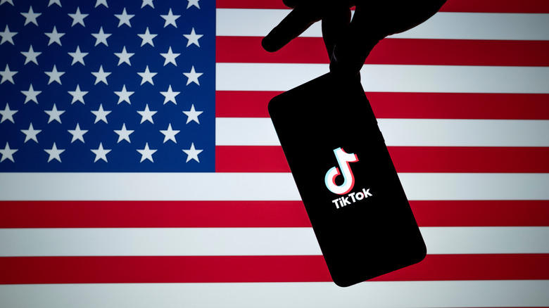 TikTok on a phone against the backdrop of the U.S. flag