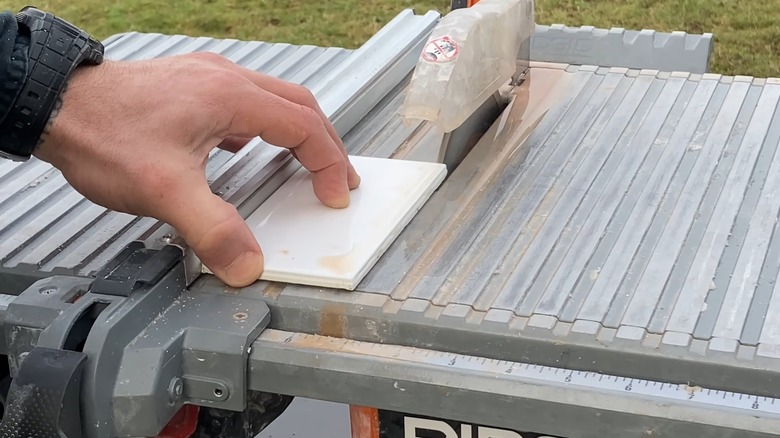A closeup of a wet saw cutting tile