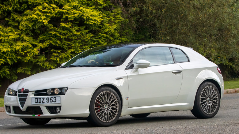 The Alfa Romeo Brera in white driving, front 3/4 view