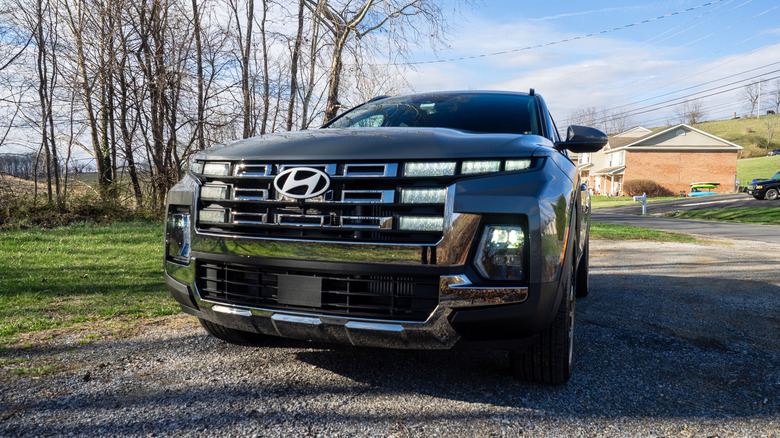 2026 Hyundai Santa Cruz front end view with daytime running lights and headlights powered on