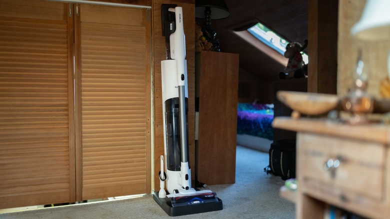 The Tineco Pure One Station 5 on its base station in a room.