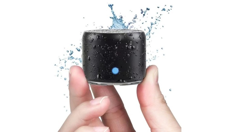 EWA portable Bluetooth speaker with water splashing on it