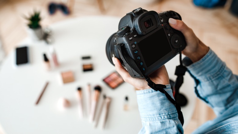 Person holding digital camera