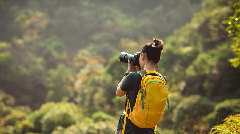 Photographer outdoors with a backpack