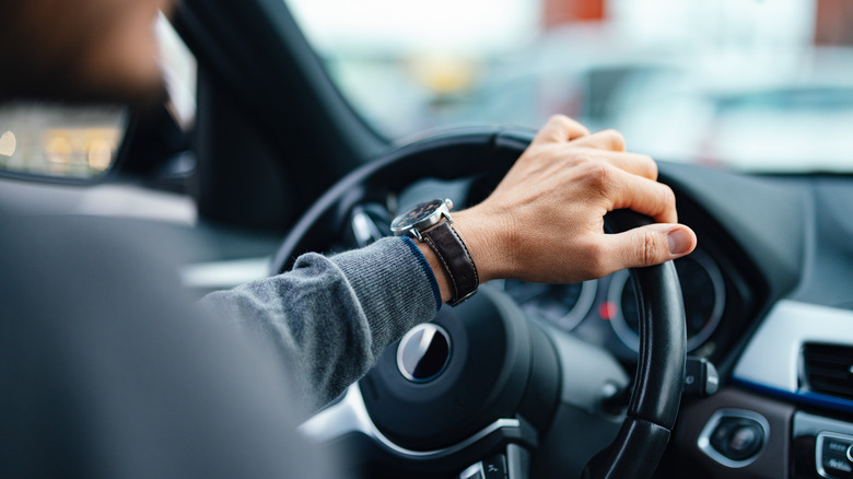 Hand on steering wheel