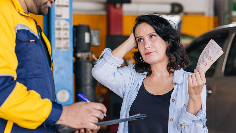 An unhappy customer having to pay the mechanic