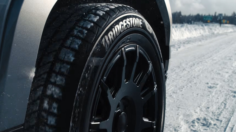SUV with Bridgestone UltraWeather tires driving on a snowy road
