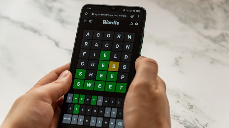 Person playing Wordle on smartphone