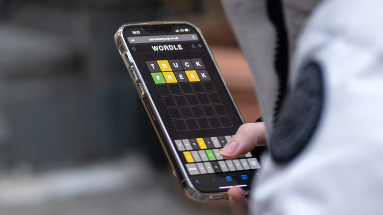 person playing Wordle on smartphone