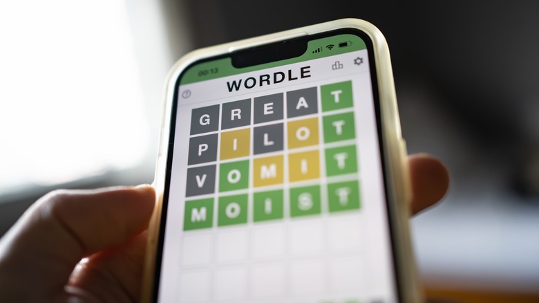 person playing Wordle on smartphone