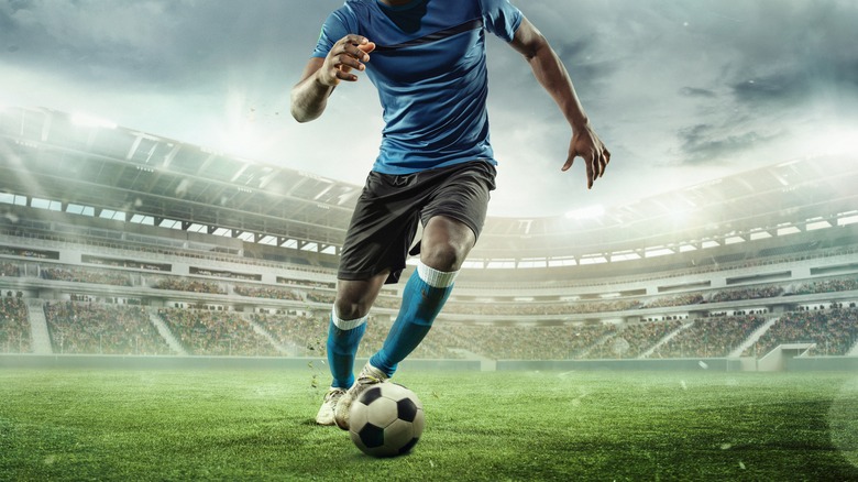 man playing football in stadium