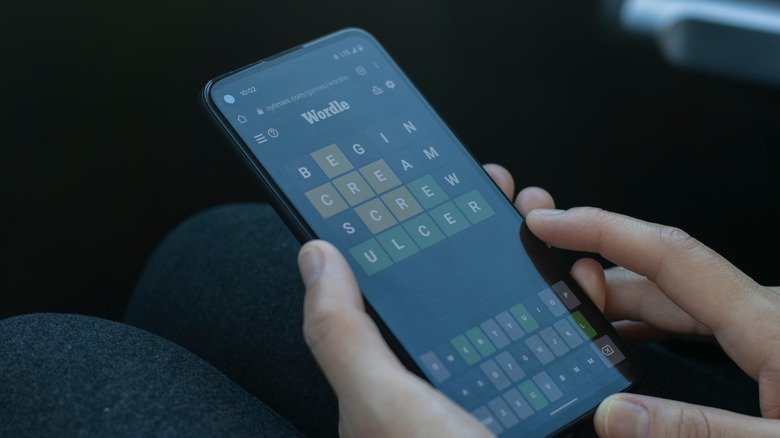 person playing Wordle on smartphone