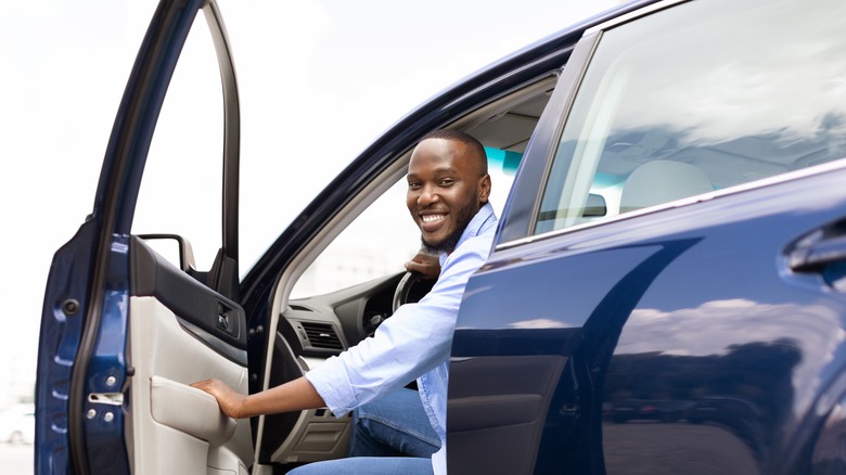 person in driver's seat of car