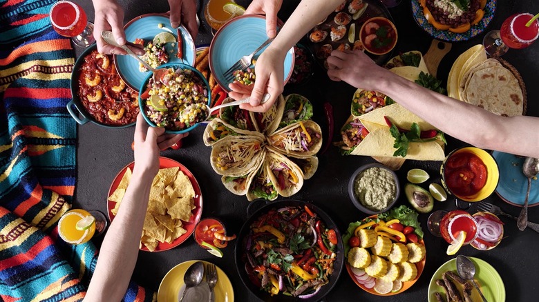 people gathered around a table with food