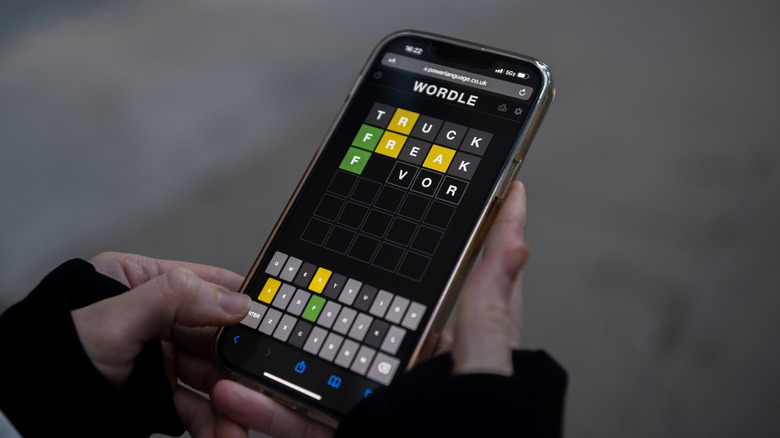 person playing Wordle on a smartphone