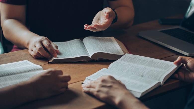 People reading books on table