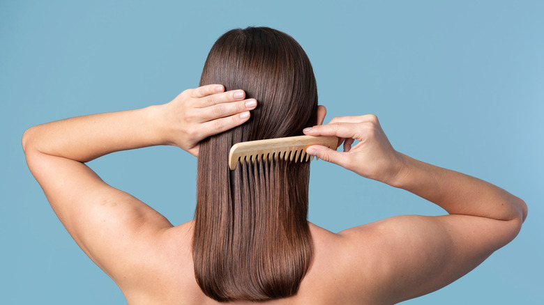 woman combing her sleek hair