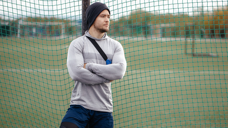 muscular man folding his arms