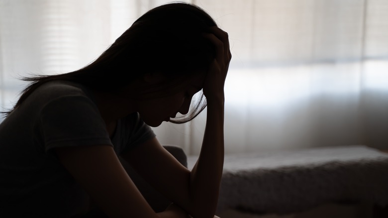person holding their head