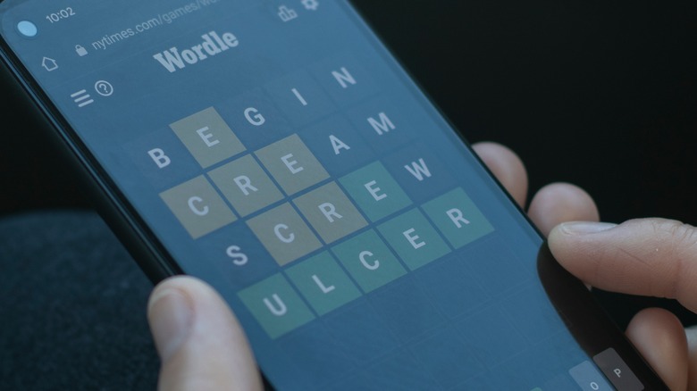 person playing Wordle on smartphone