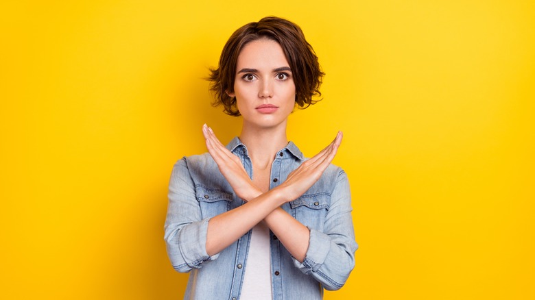 person frowning and crossing arms