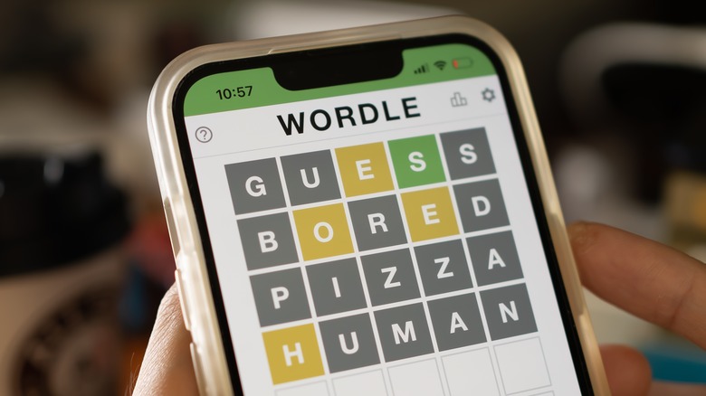 person playing Wordle smartphone