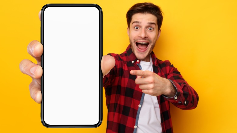 man holding a giant smartphone