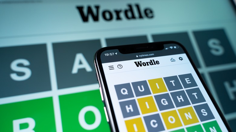 person playing Wordle smartphone