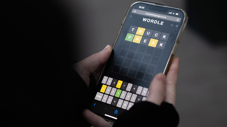 person playing Wordle on smartphone