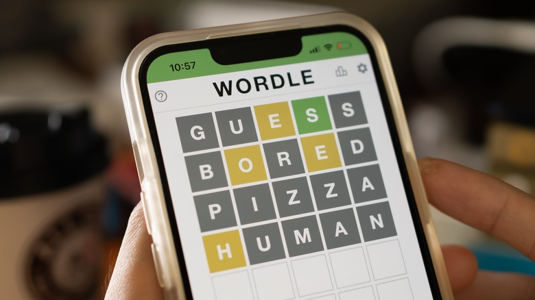 person playing Wordle smartphone