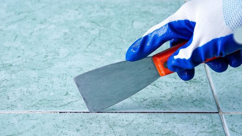closeup of person laying tile