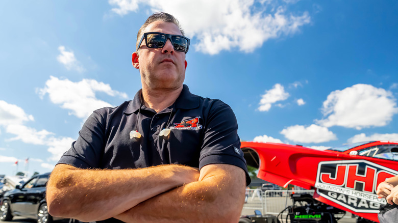 Tony Stewart at NHRA event with arms crossed