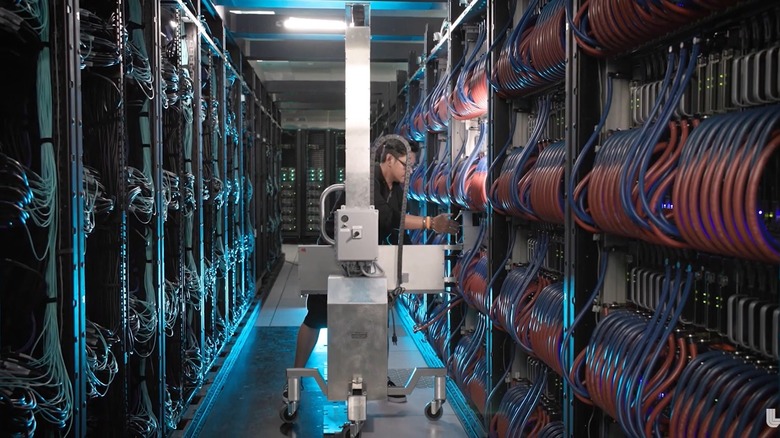 Man working inside a cabling room of the El Capitan supercomputer.