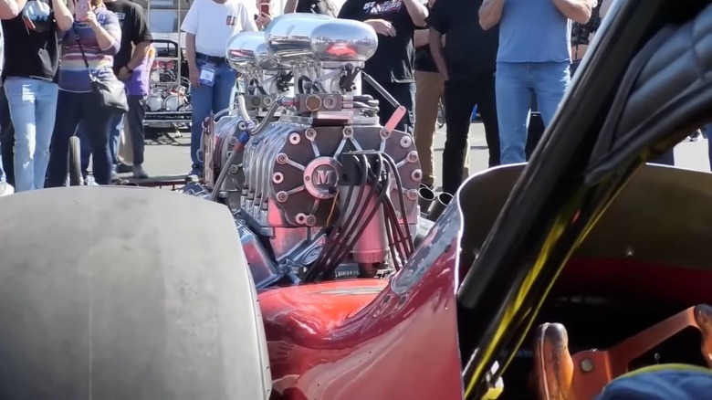 View from beside driver's seat looking at twin-engine dragster's engines