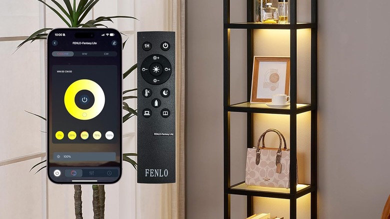 A phone showing the Fenlo app next to a Fenlo remote, next to a Fenlo glass cabinet with a purse, cologne, a photo frame, and a coffee cup inside.