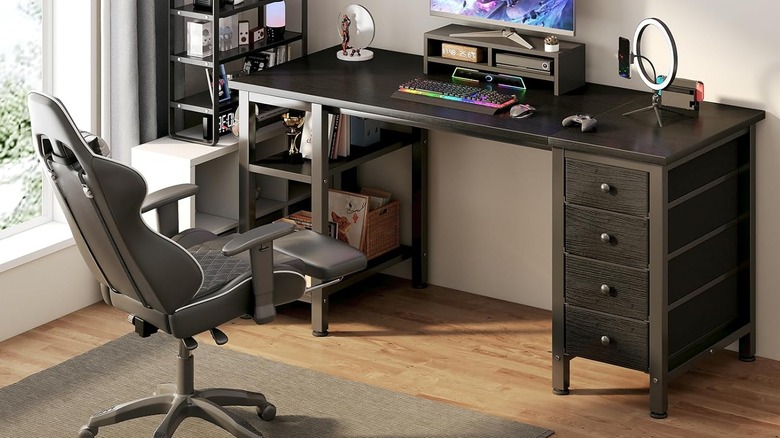 A gaming desk with a Nintendo switch, a circular light, and a monitor plugged in.