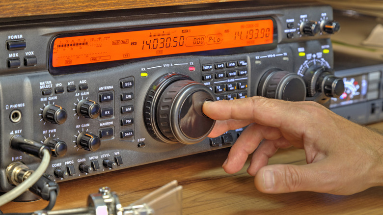 Hand moving knob on radio
