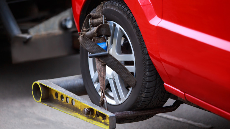 Closeup of car front wheel in a tow rig