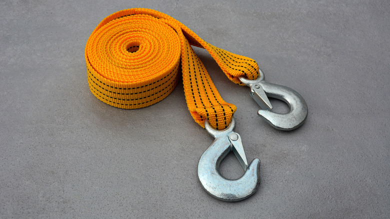 Rolled up tow strap with metal hooks