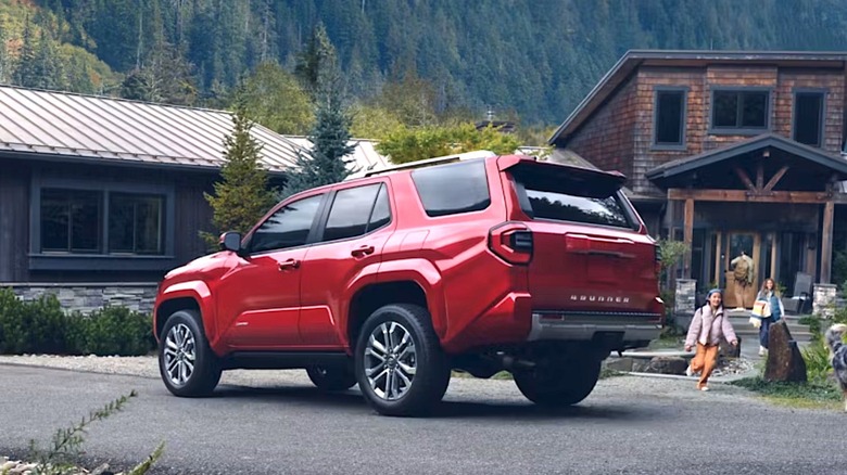 Kids running towards a Toyota 4Runner parked in driveway