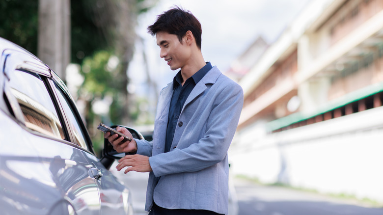Person using a phone to unlock their car