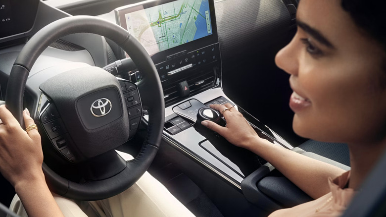 Woman driving in a Toyota RAV4 with the navigation on