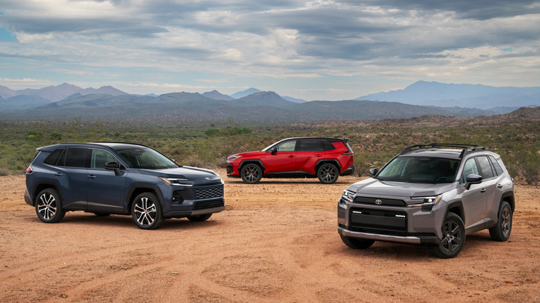 Blue, gray, and red 2026 Toyota RAV4s parked on desert trail.
