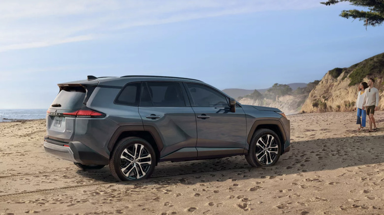 Steel blue Toyota RAV4 parked on beach facing to the right