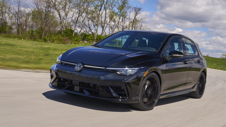 Front 3/4 view of black Volkswagen Golf R cornering.