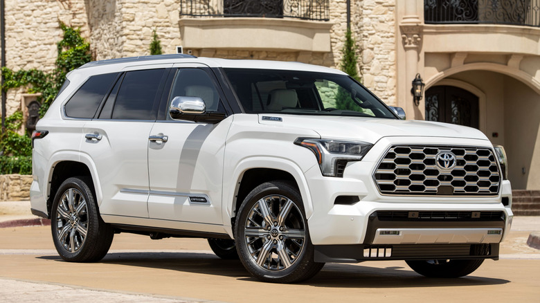 A white 2025 Toyota Sequoia in front of a home